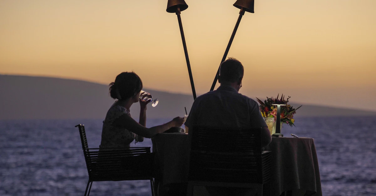 a man and a woman sitting at a table next to each other