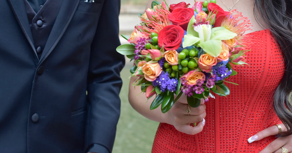 a woman in a red dress holding a bouquet of flowers