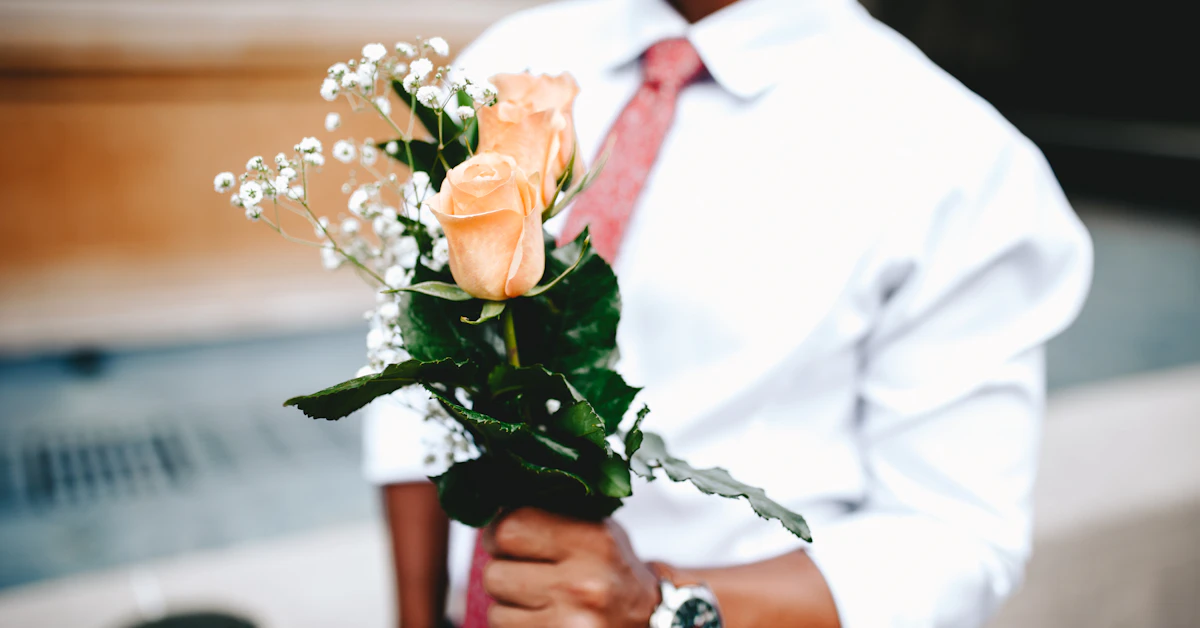 a man holding a bouquet of flowers in his hands