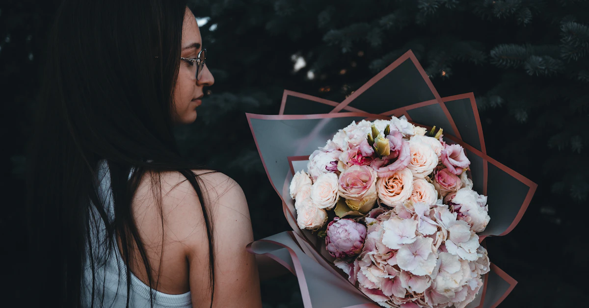 A woman holding a bouquet of flowers in her hand