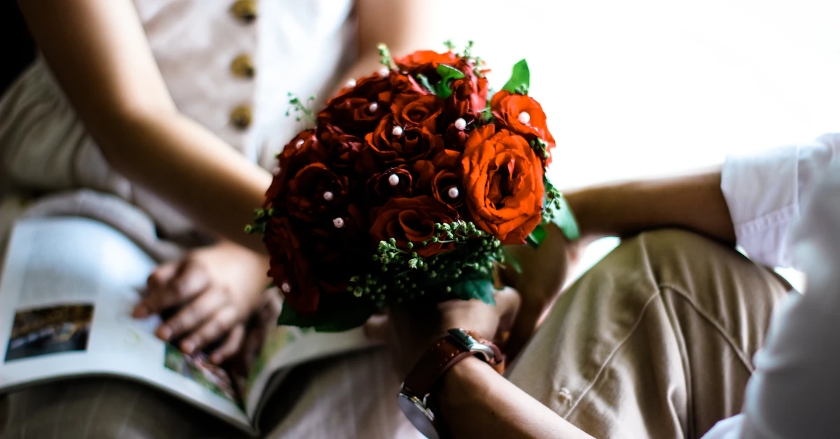 man holding red bouquet of flowers