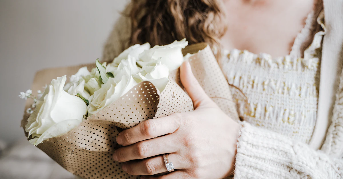a close up of a person holding a bouquet of flowers