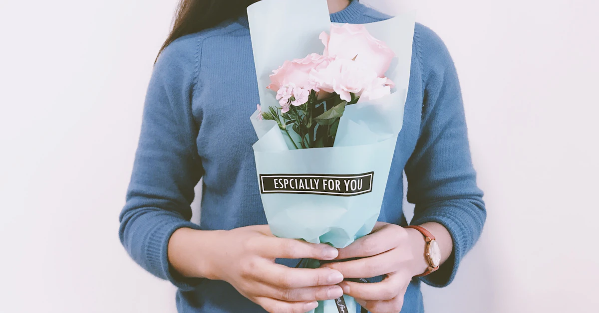 woman holding pink flower bouquet